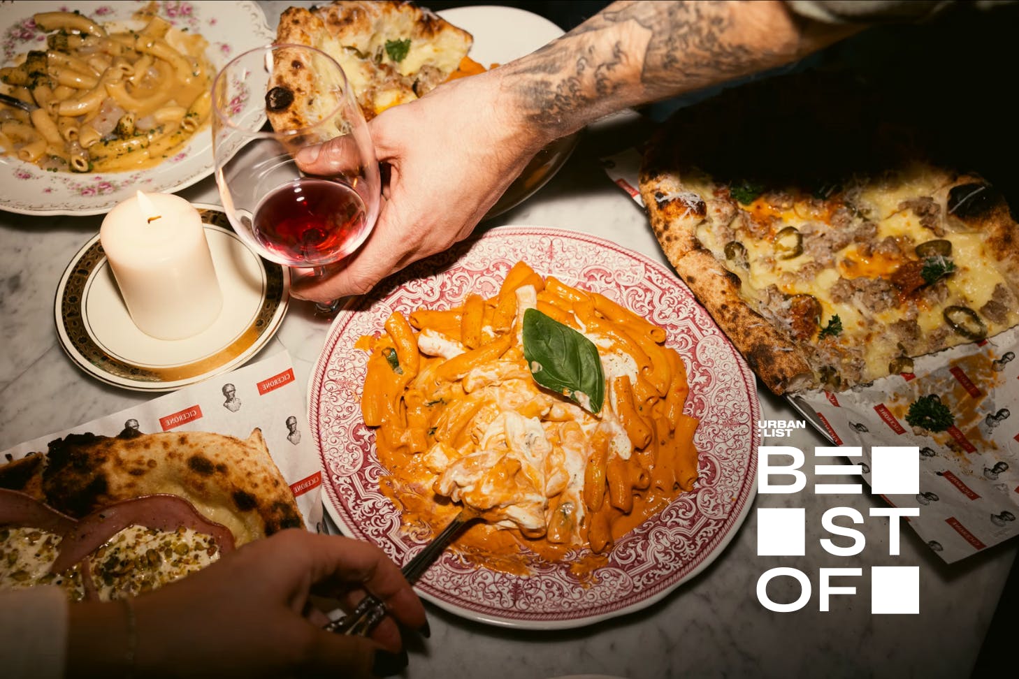 Hands reaching for dishes of pizza and pasta at Cicerone in Surry Hills